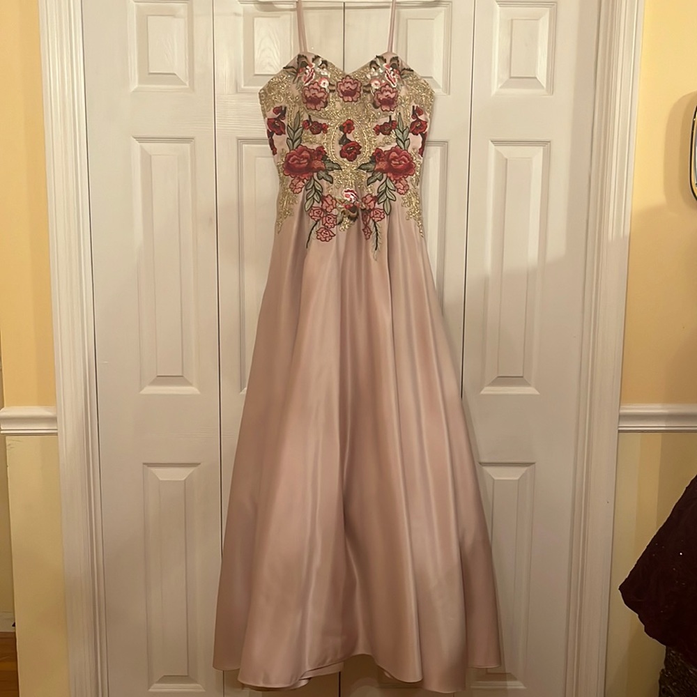 A pink fit and flare prom dress with a corset back and optional spaghetti straps